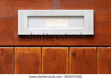 Letter box on wooden background.