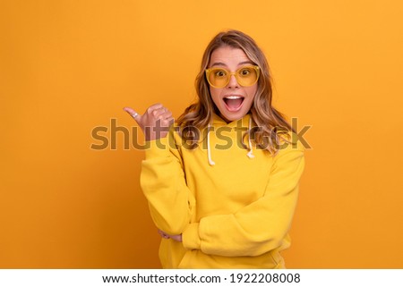 Similar – Image, Stock Photo Woman in yellow hoodie taking selfie on smartphone on rocky shore