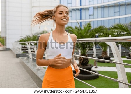 Image, Stock Photo Fit woman on vacation doing stretching exercises over the city in the summer afternoon in front of the Alhambra.