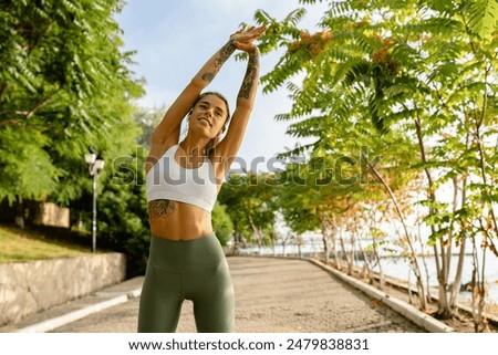 Similar – Image, Stock Photo Happy woman stretching legs during yoga class with trainer