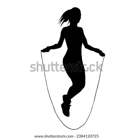 Silhouette of a slim sporty woman doing jump rope workout.