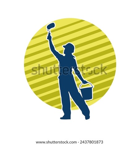 Silhouette of a female worker doing painting work. Silhouette of an interior painter worker.
