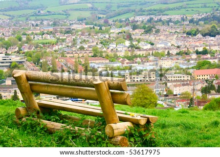 A rustic bench overlooking the city of Bath