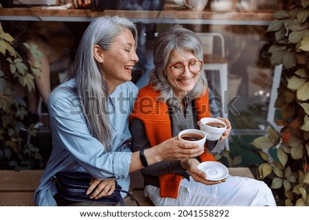 Similar – Image, Stock Photo Best female friends near lake during holiday