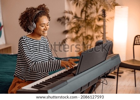 Similar – Image, Stock Photo Smiling woman playing piano in living room