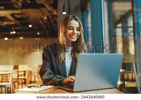 Similar – Image, Stock Photo A student sits on the stairs on campus and reads a book, next to her is a glass of coffee