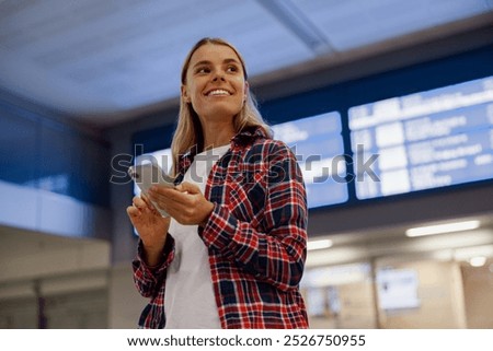 Similar – Image, Stock Photo Casual woman on airport terminal talking on the cell phone, waiting for flight departure with luggage on trolley cart.