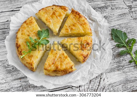 potato tortilla on a light wooden surface