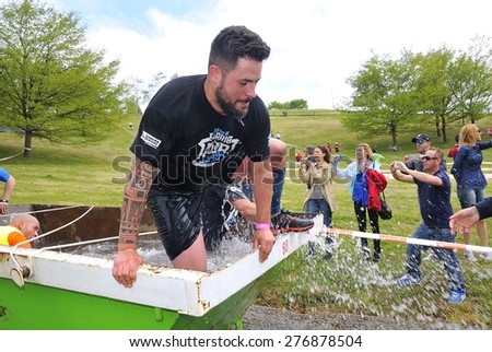 OVIEDO, SPAIN - MAY 9: Storm Race, an extreme obstacle course in May 9, 2015 in Oviedo, Spain. Runner in the container of ice water.