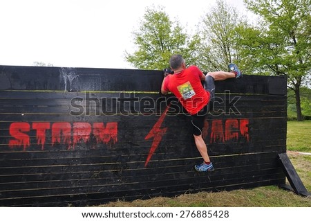 OVIEDO, SPAIN - MAY 9: Storm Race, an extreme obstacle course in May 9, 2015 in Oviedo, Spain. Runner jumping a wooden wall.