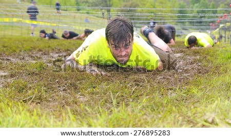 OVIEDO, SPAIN - MAY 9: Storm Race, an extreme obstacle course in May 9, 2015 in Oviedo, Spain. Runners crawled under barbed wire.