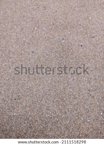 The beach atmosphere with its distinctive sand during the day, blurred background