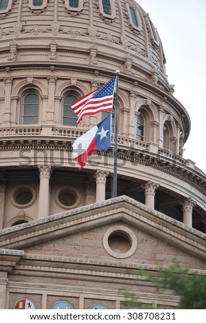 Close up of the Texas State Capital and flags waving