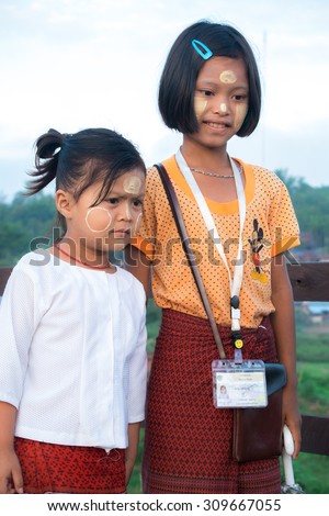 Sangklaburi,Thailand May 31: Unidentified young asian girls smile and doubt with thanaka powder on face of this \