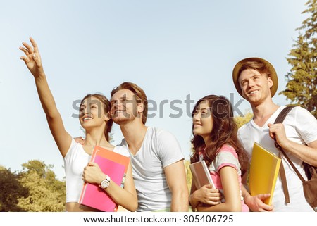 Funny carefree students walk in the park