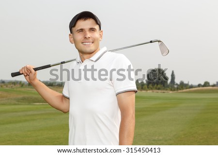 Young golf player holding a niblick outdoors