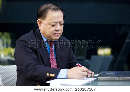 Asian businessman writing business proposal