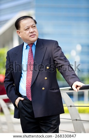 Asian businessman in suit smiling