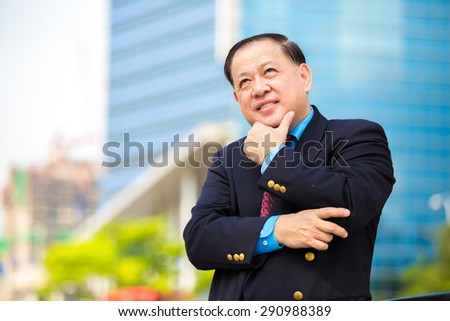 Asian senior businessman in suit portrait smiling