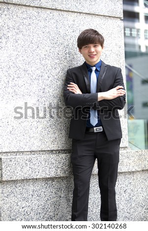 Young Asian male business executive in suit smiling portrait