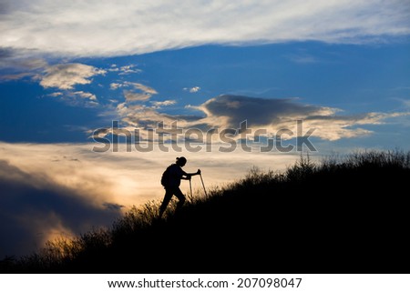 Mountain hiker in front of sunset