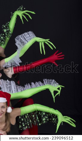 Christmas theatrical performance Young female actress make a theatrical composition with green and red gloves