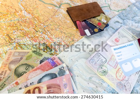 Global adventure background. Unfolded detailed maps exotic country cash notes passport entry stamps credit cards colored wallet