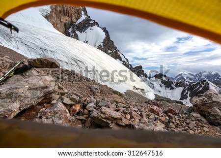 Mountain View from Yellow Tent.\
Landscape from Camping Tent Vanishing Point Steep Glacier Tongue  Ice and Rock Cliff Terrain Alpine Gear