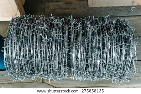 coil of barbed wire on the counter in the store . building materials store in the open air