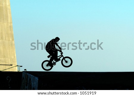 Young jumping with bicycle