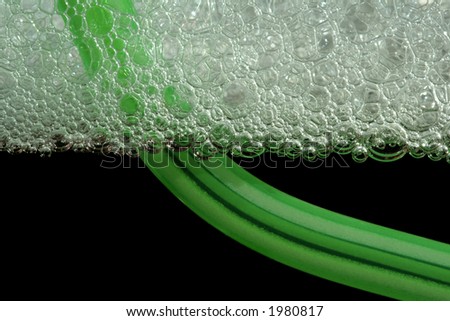Cooling drink white bubbles on cup with a green straw