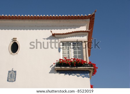 Typical medieval building with beautiful flowers in the window