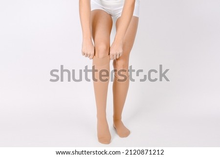 Medical Compression Stockings for varicose veins and venouse therapy. Compression Hosiery. Sock for sports isolated on white background. Beige color socks mock up for advertising, branding, design. ストックフォト © 