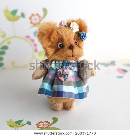 Brown artist Teddy bear in blue clothes with grey dog