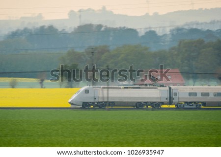 Similar – Image, Stock Photo Passenger train and rapeseed field. Spring landscape at sunrise