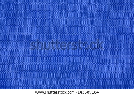 Close view of a wrinkled water resistant blue nylon fabric.