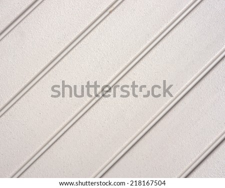 A background of plastic with inset grooves at an acute angle.