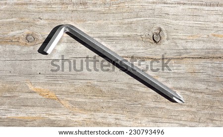 A single purpose phillips screwdriver with an acute hexagon end for assembling furniture on a wood background.