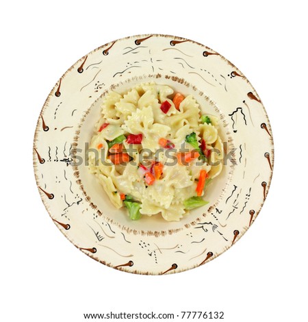 A single serving of pasta Primavera in a southwestern style bowl on a white background.