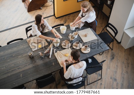 Similar – Image, Stock Photo Woman making ceramic work with potter’s wheel