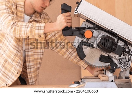 Similar – Image, Stock Photo Unrecognizable handyman using machine on factory