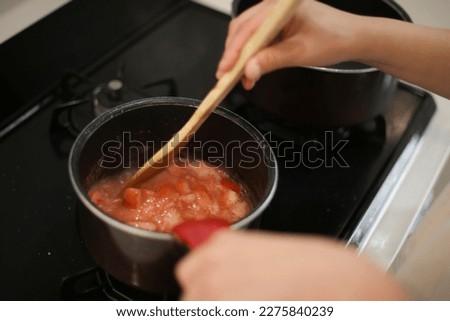 Similar – Image, Stock Photo Housewife making strawberry jam. Woman cutting fruits