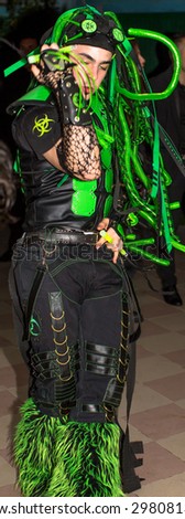 Modena, Italy - September 21, 2014: Cyber dancer boy in black and fluorescent green dancing, during event: Dynamika Trauma, music by Dj Slimer.