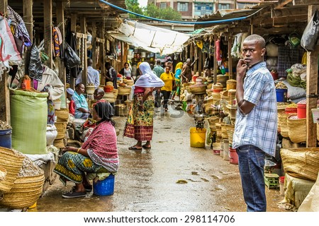 Arusha, Tanzania, Africa - January 2, 2013: Teenager on the road within  market of the town