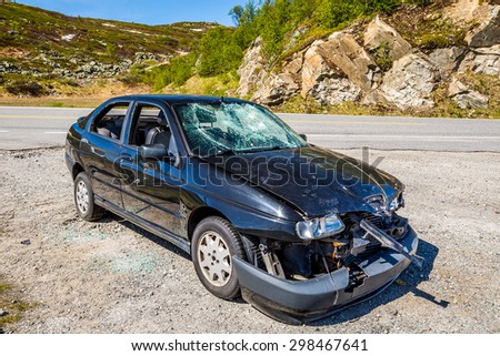 highway 7, Norway, Europe - June 15, 2014: a badly damaged car parked on a bend of the road after an incident the day before