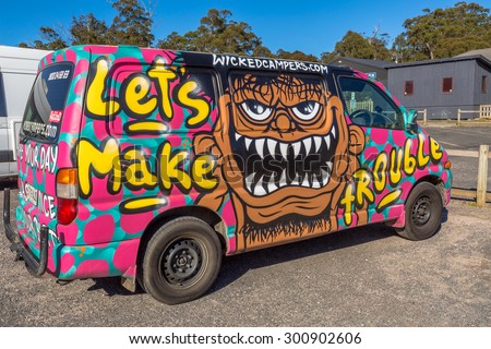 Sydney, Australia - January 9, 2015: Hippie van with Lets Make Trouble airbrushing hand made. Typical campers from Australian company: Wickedcampers.