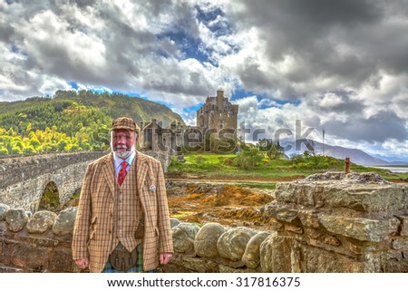Dornie, Kyle of Lochalsh, Scotland, United Kingdom - May 28, 2015: Tour guide in traditional Scottish dress in front of the entrance to the famous Eilean Donan Castle in a cloudy day