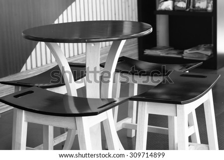 black wood table and chair set in cafe in black and white style