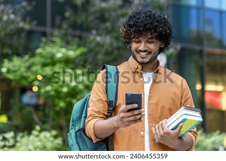 Similar – Foto Bild Student mit Rucksack beim Tippen auf Laptop und Notizblock im Park an hellem Tag