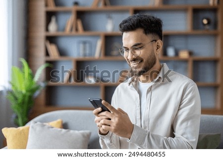 Similar – Image, Stock Photo Man using a mobile phone sitting on the grass with a sports bag